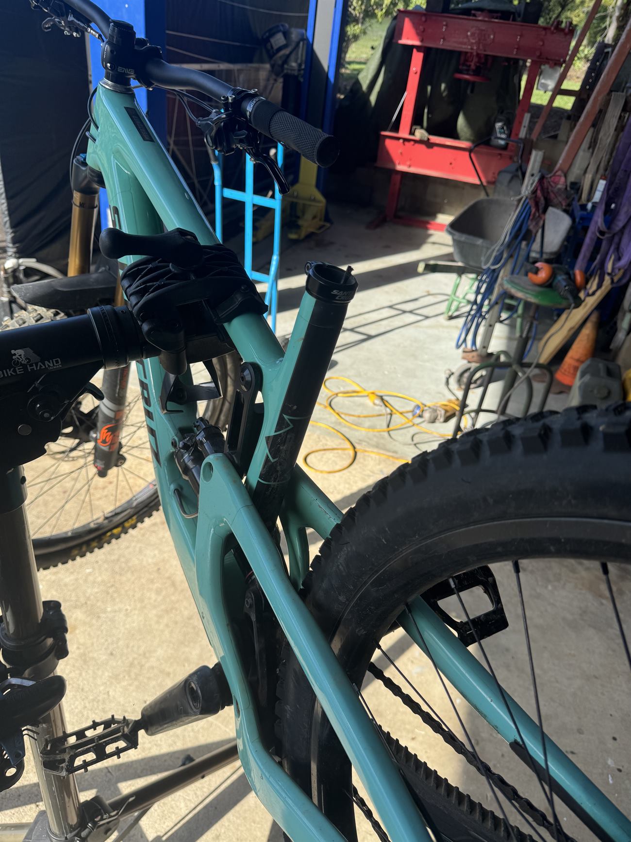 Full suspension mountain bike up in the repair stand